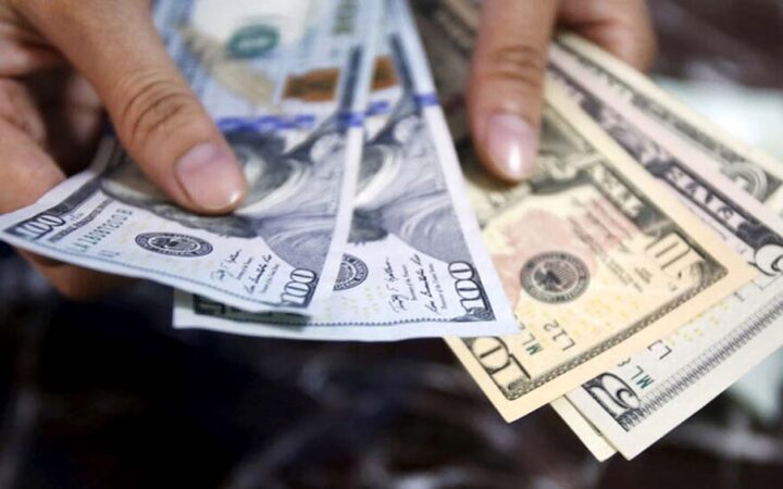 FILE PHOTO -  An employee checks U.S. dollar bank-notes at a bank in Hanoi, Vietnam